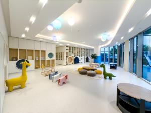 a large room with tables and toy dinosaurs in it at Bella Elite Homes at Grande Signature Burj and Fountain Great Full View- Brand New Luxury Apartement in Dubai