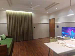 a living room with a couch and a table at Gulzar 1BHK Service Apartment, kannur in Kannur