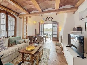 a living room with a couch and a tv at Roca Fornells, P131 in Fornells +56 photos