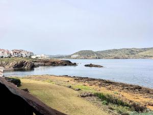 a view of a body of water with houses at Roca Fornells, P131 in Fornells