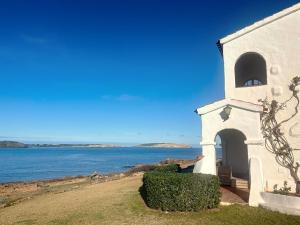a white building with a view of the water at Roca Fornells, P131 in Fornells