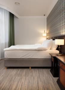 Postel nebo postele na pokoji v ubytování Brovaria Boutique Hotel Stary Rynek - Old Town Square
