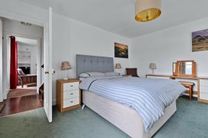 Finest Retreats - Lochead Cottage في Achahoish: غرفة نوم بها سرير كبير ومكتب