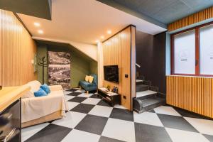 a room with a bedroom with a checkerboard floor at Arena Albaro House in Genoa