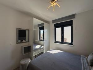 a bedroom with a bed and a window at Golden Sunset 3 in Njivice