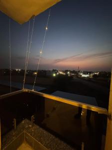a view from the roof of a building at night at Skyfarm Resort in Barāgaon +6 photos