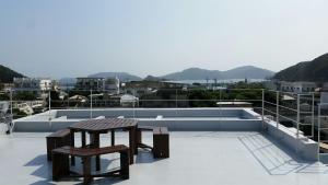 a pair of benches sitting on top of a roof at Shima Stay holoholo in Zamami