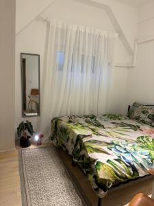 a bedroom with a bed with a curtain and a mirror at Capital Apartmani Zagreb 2 in Zagreb
