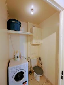 a small bathroom with a washing machine and a toilet at Chic and comfortable apart with Parking and Terrace in Asnières-sur-Seine +18 photos