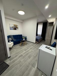 a living room with a blue couch and a table at Family Guest House in Yerevan