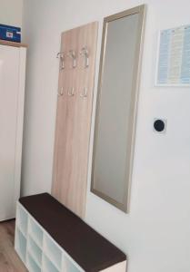 a bathroom with a mirror on the wall and a bench at Urban Retreat in Osijek