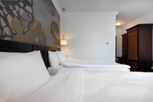 Postel nebo postele na pokoji v ubytování Brovaria Boutique Hotel Stary Rynek - Old Town Square