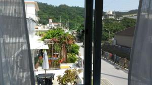 a view of a street from a window at Shima Stay holoholo in Zamami