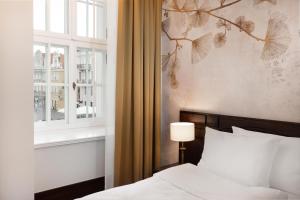 Postel nebo postele na pokoji v ubytování Brovaria Boutique Hotel Stary Rynek - Old Town Square