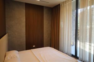 a bedroom with a bed and a large window at Natural Pool & SPA in Ferizaj