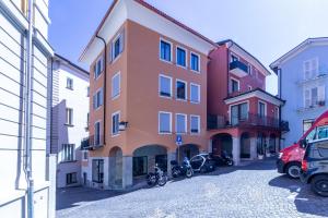 a group of motorcycles parked in front of a building at Essenzial Piazza Grande Locarno in Locarno