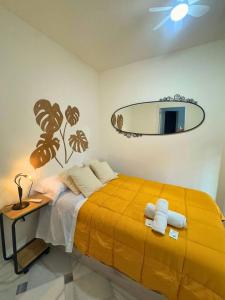 a bedroom with a large bed and a mirror at Home4u Acogedor apartamento en Maracena in Maracena