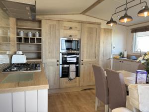 a kitchen with a stove and a microwave at 256 North Park in North Seaton