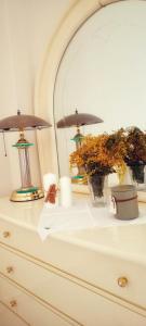 a dresser with two lamps and a mirror on it at Zoe's Villa - Entire Villa Rental with Stunning Aegean Sea views! in Playiá