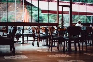 a restaurant with tables and chairs and a person sitting at a table at Grand Şelale Hotel in Cayeli
