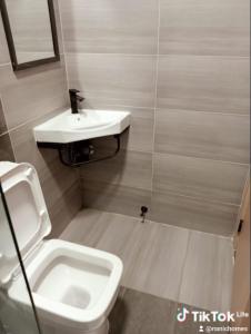a bathroom with a sink and a toilet at Nanic Homes Rio Vista in Marimbeti +8 photos