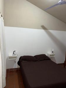 a bedroom with a black bed and two sinks at Casa de 3 dormitorios - Palpalá in Palpalá