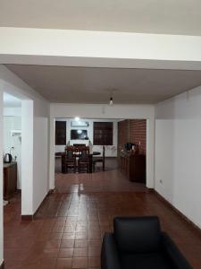 a living room with a couch and a dining room at Casa de 3 dormitorios - Palpalá in Palpalá