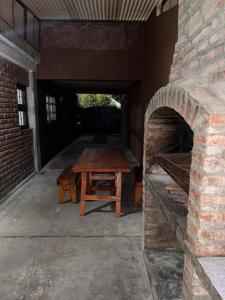 a wooden table sitting inside of a brick oven at Casa de 3 dormitorios - Palpalá in Palpalá +3 photos