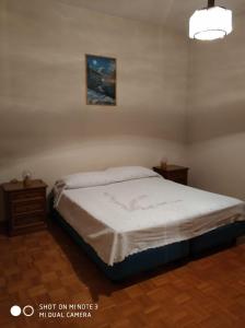 a bedroom with a bed and two night stands at Appartamento mare in Cesenatico