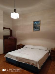 a bedroom with a bed and a dresser and a mirror at Appartamento mare in Cesenatico +13 photos