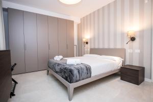 a bedroom with a bed with two towels on it at Compagnoni Luxe - Terrace & SPA in Milan