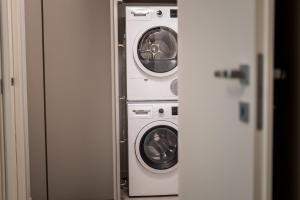 three washing machines in a room with a door at Compagnoni Luxe - Terrace & SPA in Milan +31 photos