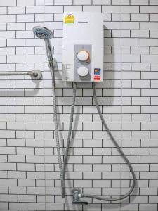 a white brick wall with a hose attached to a shower at Golden Palm Resort in Krabi town +39 photos