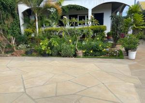 a patio in front of a house with plants at Appart Cozy Ivandry dans villa in Antananarivo