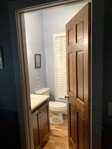 a bathroom with a toilet and a sink at Secluded Woodland Cabin Rental with Hot Tub in Yadkin Valley Wine Region in Elkin +5 photos