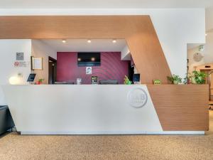 a lobby with a reception counter in a hospital at B&B Hotel Milano San Siro in Milan