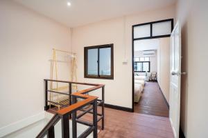 a room with a staircase and a room with a bedroom at OH Homes - Samsen 12 in Bangkok
