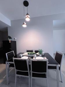 a dining room with a table and chairs at BIG Two Bedrooms 1-6 Pax Luxury Condo at D Secret Garden - Johor Bahru-Setia Tropika-UTM-Mid Valley-Paradigm Mall in Johor Bahru
