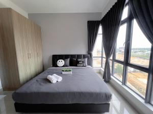 a bedroom with a large bed with two towels on it at BIG Two Bedrooms 1-6 Pax Luxury Condo at D Secret Garden - Johor Bahru-Setia Tropika-UTM-Mid Valley-Paradigm Mall in Johor Bahru