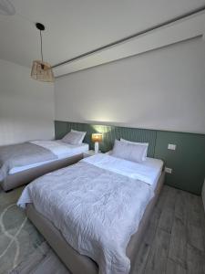 two twin beds in a room with at appartement Sarra Mahdia in Hiboun