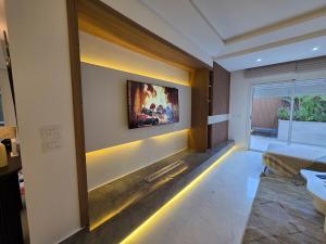 a living room with a tv on the wall at appartement Sarra Mahdia in Hiboun
