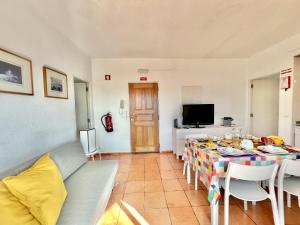 a living room with a table and a couch at Albufeira Skylight 2 by Homing in Vale de Pedras