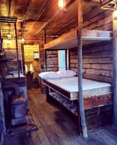 a bedroom with a bed in a log cabin at Rustic Container Accommodation for Glamping in Kentucky in Owenton