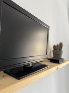 a flat screen tv sitting on a wooden shelf at ZenZone House in La Spezia +18 photos