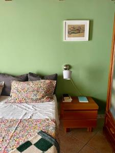 a bedroom with a bed and a table with a lamp at La Beata Giovanna in Mesagne