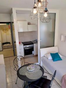 a living room with a table and a couch at Apartmani Jessica in Novalja