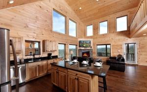 a kitchen with a large center island in a wooden house at Breathtaking Cabin with Hot-tub, Fireplace and Games in Sevierville, Tennessee in Little Cove