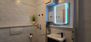 a bathroom with a sink and a mirror at Ferienwohnung P5 in Graal-Müritz +9 photos