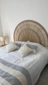 ein großes Bett mit weißen Laken und Kissen in der Unterkunft A LAVANDA Maison BONIFACIO in Bonifacio