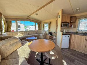 a living room with a couch and a table in a caravan at Lovely 6 Berth Caravan Nearby Hunstanton Beach In Norfolk Ref 23071T in Hunstanton